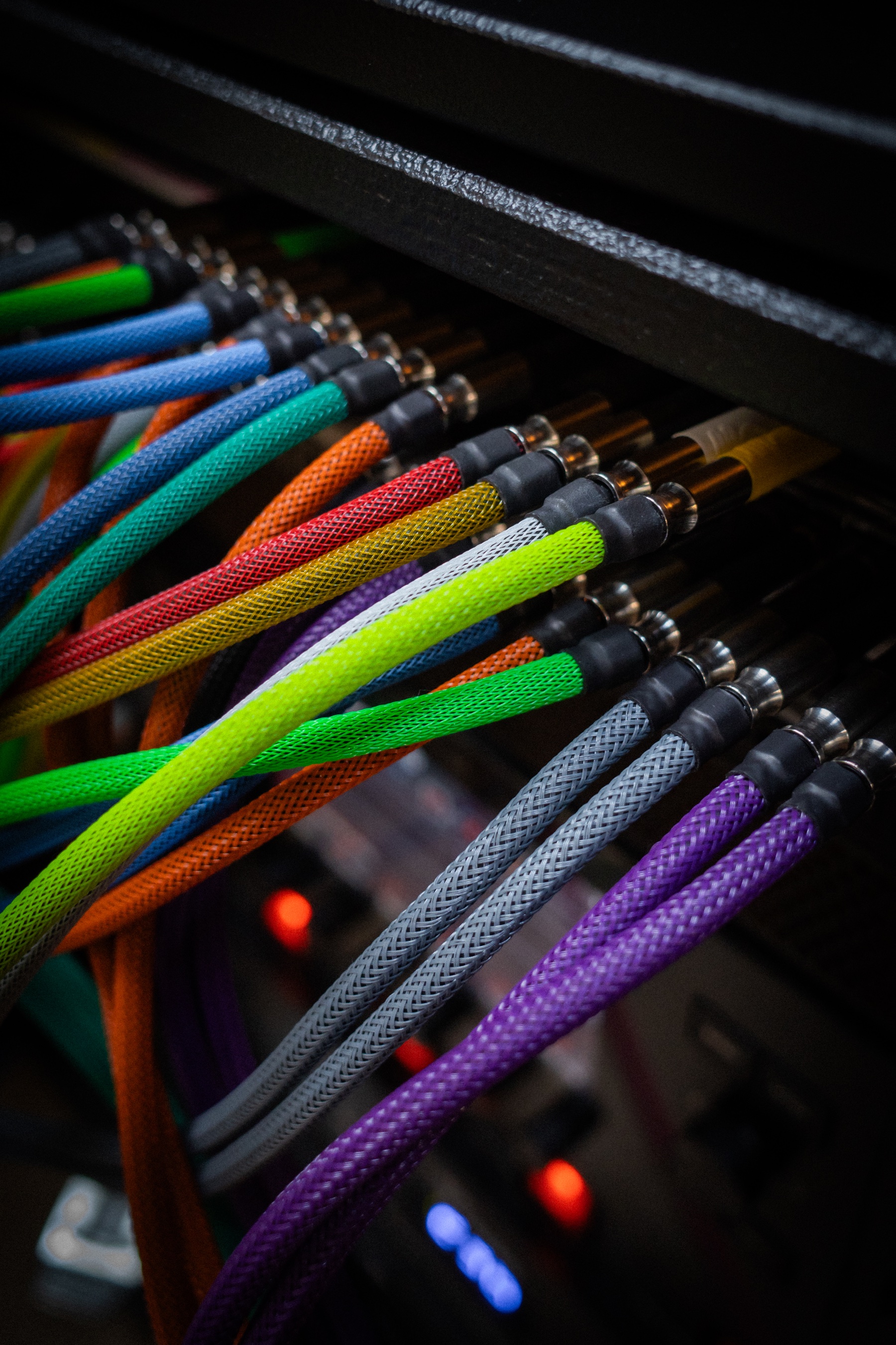 Colorful studio patch cables connected to professional audio equipment